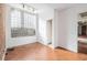 Room with exposed brick wall, glass block window, and hardwood floors at 1112 Delaware Se Ave, Atlanta, GA 30316