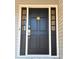 Elegant dark wood front door with a decorative lion door knocker at 5023 Vernon Oaks Dr, Atlanta, GA 30338