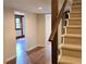 Hallway with carpeted stairs, wood-look floors, and doorways to other rooms at 5023 Vernon Oaks Dr, Atlanta, GA 30338