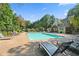 Inviting community pool surrounded by lounge chairs at 925 Seasons Pkwy, Norcross, GA 30093