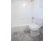 White bathroom with a shower/tub combo and gray tile floor at 1004 Forrest Se Dr, Atlanta, GA 30354