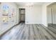 Dining area with gray wood-look floors, glass double doors leading to back deck at 1004 Forrest Se Dr, Atlanta, GA 30354