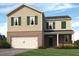 Two-story house with brick and siding, green shutters, and a two-car garage at 8211 Bluewater Dr, Fairburn, GA 30213