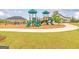 Community playground with playset, slides, and shaded seating at 305 Bianca Way, Mcdonough, GA 30253