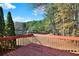 Spacious backyard deck with wooden railings, overlooking trees at 14 Glenmore Dr, Kingston, GA 30145