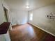 Simple bedroom with wood floors and a window at 2385 Perkerson Sw Rd, Atlanta, GA 30315