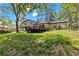 Elevated deck overlooks a spacious, grassy backyard surrounded by trees at 67 Heron Dr, Riverdale, GA 30274