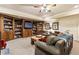 Cozy basement living area with built-in bookshelves, comfortable seating, and a large TV at 8647 Ellard Dr, Alpharetta, GA 30022