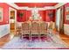 Dining room with red coffered ceiling, chandelier, and hardwood floors at 8647 Ellard Dr, Alpharetta, GA 30022