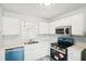 Updated kitchen with white cabinets, stainless steel appliances, and white tile backsplash at 3820 Waldrop Ln, Decatur, GA 30034