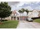 Brick two-story house with gray shutters, attached two-car garage, and manicured lawn at 4617 Stone Ln, Stone Mountain, GA 30083