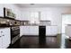 Modern kitchen with white cabinets, granite counters, stainless steel appliances, and dark hardwood floors at 4617 Stone Ln, Stone Mountain, GA 30083