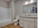 Bathroom with white vanity, granite countertops, and a bathtub/shower combination at 4230 Moore Rd, Conley, GA 30288