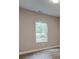 Empty bedroom with neutral walls, carpet, and a window at 4230 Moore Rd, Conley, GA 30288