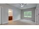 Bedroom with ensuite bathroom, neutral colored walls and carpeting, and large window at 4230 Moore Rd, Conley, GA 30288