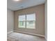 Unfurnished room with neutral colored walls and carpeting, and two large windows at 4230 Moore Rd, Conley, GA 30288