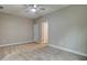 Spacious bedroom with neutral walls, plush carpeting, and a ceiling fan at 4230 Moore Rd, Conley, GA 30288