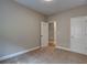 Bedroom with neutral colored walls and carpeting, ceiling fan, and ensuite bathroom access at 4230 Moore Rd, Conley, GA 30288