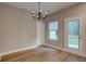Dining area with modern chandelier and access to the backyard at 4230 Moore Rd, Conley, GA 30288