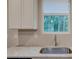 Kitchen with white shaker cabinets, granite countertops, and stainless steel sink at 4230 Moore Rd, Conley, GA 30288
