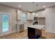 Kitchen with island, stainless steel appliances, and white shaker cabinets at 4230 Moore Rd, Conley, GA 30288