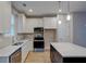 Bright kitchen featuring white cabinets, stainless appliances, and an island at 4230 Moore Rd, Conley, GA 30288