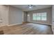 Spacious living room with large window and wood-look floors at 4230 Moore Rd, Conley, GA 30288