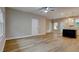 Open-concept living area with wood-look flooring and modern light fixtures at 4230 Moore Rd, Conley, GA 30288