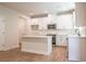 Modern kitchen with white cabinetry, island, and stainless steel appliances at 138 Henley St, Canton, GA 30114