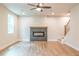 Living room featuring a modern fireplace, hardwood floors, and a ceiling fan at 138 Henley St, Canton, GA 30114