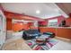 Finished basement with orange walls, a couch, and a collection of action figures at 2291 Wilkins Ct, Decatur, GA 30035