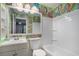 Bathroom with green paisley wallpaper, white bathtub, and single vanity at 2291 Wilkins Ct, Decatur, GA 30035