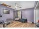 Purple bedroom with a bed, ceiling fan, and exercise equipment at 2291 Wilkins Ct, Decatur, GA 30035