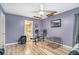 Purple bedroom with exercise equipment, a dog crate, and a view of an attached bathroom at 2291 Wilkins Ct, Decatur, GA 30035