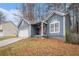 Two-story home with a covered porch, attached garage, and front yard at 2291 Wilkins Ct, Decatur, GA 30035