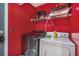 Red laundry room with washer, dryer, and overhead storage at 2291 Wilkins Ct, Decatur, GA 30035