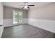 Bedroom featuring wood paneling and large window offering ample natural light at 803 Silverbell Ct, Stockbridge, GA 30281