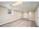 Spacious, carpeted basement room with a window and door at 1767 Big Horn Se Ct, Conyers, GA 30013