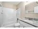 Full bathroom with tiled shower, granite vanity, and white cabinets at 1767 Big Horn Se Ct, Conyers, GA 30013