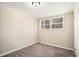 Empty bedroom with neutral walls, carpet, and a window with blinds at 1767 Big Horn Se Ct, Conyers, GA 30013