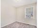 Cozy bedroom with neutral walls, carpeting, and a window at 1767 Big Horn Se Ct, Conyers, GA 30013