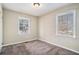 Bedroom with plush carpet and two large windows offering natural light at 1767 Big Horn Se Ct, Conyers, GA 30013
