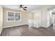 Bright living room with wood-look flooring, ceiling fan, and staircase at 1767 Big Horn Se Ct, Conyers, GA 30013
