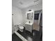 Bathroom boasts marble tile, black hexagon floor, and modern vanity at 2981 Grand Sw Ave, Atlanta, GA 30315