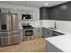 Updated kitchen with stainless steel appliances, gray cabinets, and herringbone backsplash at 2981 Grand Sw Ave, Atlanta, GA 30315