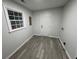 Bright laundry room with gray wood-look flooring and white door at 4498 Ginger Wood Ct, Stone Mountain, GA 30083