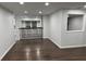 Open living area with wood floors, railing, and a glimpse of the adjacent room at 4498 Ginger Wood Ct, Stone Mountain, GA 30083