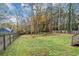 Spacious backyard with a fenced perimeter and lush green grass at 1299 Paddocks Way, Powder Springs, GA 30127
