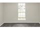 Spacious bedroom with grey carpet and large window at 1299 Paddocks Way, Powder Springs, GA 30127