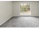 Bright bedroom with grey carpet and large window at 1299 Paddocks Way, Powder Springs, GA 30127